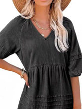 Black denim mini dress with v-neckline and tiered skirt featuring casual puff sleeves for everyday wear