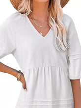 Off-white soft v-neck mini dress with three-quarter sleeves and tiered ruffles, styled as a casual denim mini dress