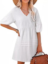 White v-neck denim mini dress with puffed sleeves and tiered hem for casual wear