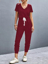 Maroon v-neck short sleeve jumpsuit with drawstring waist, machine wash cold