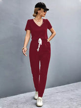 Maroon velour v-neck short sleeve jumpsuit with white drawstring waist, machine wash cold