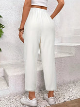 White wide leg cropped pants with high waist soft flowing fabric and delicate lace trim at the hem
