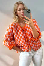 Pink and white checkered blouse with ruffled sleeves and lace-up front