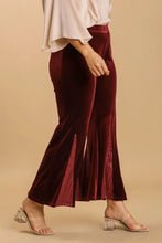 A pair of umgee plus size deep burgundy velvet flare leg pants with a size sequin elastic waistband panel