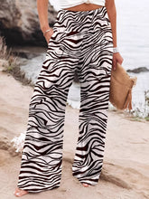 Plus size zebra print high waist wide leg pants in black and white zebra stripes for stylish comfort