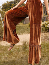 Copper-colored velvet high waist wide leg pants with tiered ruffle detail at the hem in velvet fabric