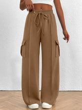 Beige casual high waist cargo pants with elastic waistband, drawstring, and large side pockets for everyday wear