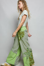 Green patchwork wide-leg pants with striped floral panels partial elastic waistband and side big star patch