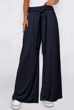 Black tied wide leg pants with pockets featuring a tied waistband for a stylish and comfortable fit