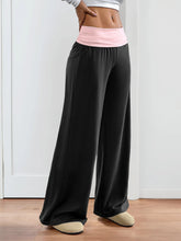 Black wide leg pants featuring a pink contrast waistband wide for stylish and comfortable wear