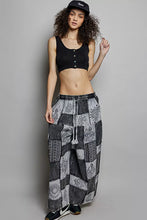 Black and white embroidered eye motif drawstring patchwork wide leg pants with relaxed fit and wide leg design