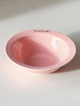 Glossy pink ceramic pet bowl with a.cute pet text on rim