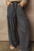 Dark gray wide leg mineral wash pants with tiered patchwork design and elastic waistband for comfortable wear