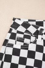 Black and white checkerboard print denim jeans with distressed details raw edges and contrasting stitching