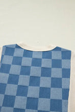 Blue and light blue checkered knit vest with cream ribbed neckline in a checkered denim patchwork short sleeve top