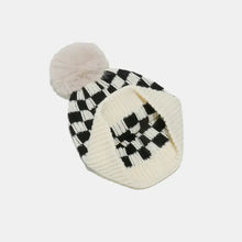 Black and white checkered knit hat with cream pom-pom