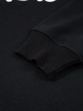 Black ribbed knit sleeve cuff with textured weave on chenille game day drop shoulder sweatshirt for machine wash use