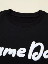 Black cotton chenille game day drop shoulder sweatshirt with bold white cursive lettering across chest machine wash safe