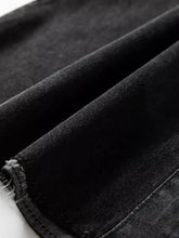 Black denim raw hem shirt dress with chest pocket featuring slightly worn texture and frayed hem detail