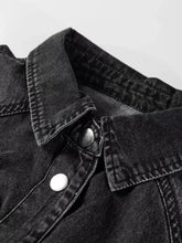 Black denim raw hem shirt dress featuring chest pocket and silver white buttons in a loose fit design