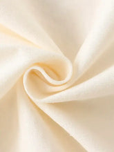 Soft cream cotton fabric with swirling texture on childrens artistic applique t-shirt, basic style