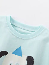 Light blue childrens t-shirt with cartoon dog graphic and panda in party hat