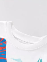 Children’s dinosaur graphic white cotton t-shirt with colorful swirls
