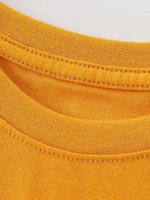 Close-up of mighty dinos t-shirt mustard-yellow cotton collar