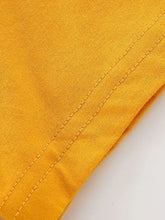 Close-up of mustard-yellow cotton seam stitching on Mighty Dinos kids t-shirt
