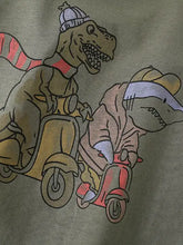 Childrens dinosaur round neck t-shirt with olive green cartoon dinos on scooters