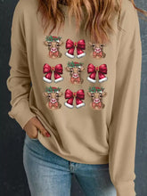 Beige long-sleeved sweatshirt with festive cartoon cows wearing santa hats and red bows for christmas wear