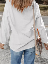 Beige crossbody bag with floral pattern and tan leather straps shown with christmas leafy boot printed corded rib sweatshirt sleeve length and care instructions including tumble dry