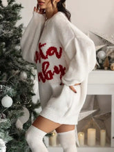 White Santa Baby knit sweater dress with red cursive lettering and oversized sleeves