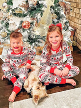 Two children and dog in matching Christmas long sleeve pajama pants set