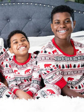 Two young boys in matching Christmas long sleeve pajama pants set