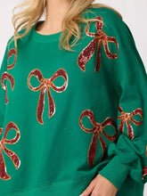 Emerald green oversized Christmas sequin bow round neck sweatshirt with sparkling red sequin bows care instructions tumble dry