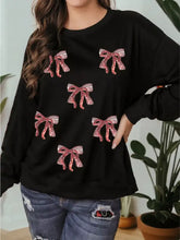 Black long-sleeved sweatshirt featuring pink and white striped sequin ribbon bows for festive wear