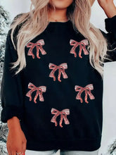 Black Christmas sweatshirt featuring rose gold sequin ribbon bows with a drop shoulder design
