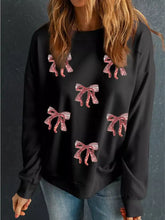 Black Christmas sweatshirt with red and white sequin ribbon bow appliqués and drop shoulder design