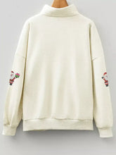 Cream-colored long-sleeved sweatshirt with high collar and sequin santa embroidery on sleeves machine wash cold