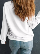 White holiday sweatshirt with christmas tree graphic, relaxed fit, ribbed cuffs, slightly stretchy, machine wash cold