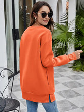 Orange long-sleeved drop shoulder sweatshirt with Christmas tree graphic