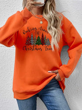 Orange long-sleeved round neck sweatshirt with christmas tree graphic