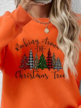 Orange round neck sweatshirt with Christmas tree graphic and text