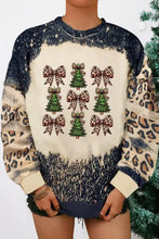 A festive christmas tree and leopard bow round neck sweatshirt with cream center and navy slightly stretchy sleeves
