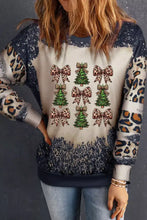 A festive beige and navy blue christmas tree and leopard bow round neck sweatshirt with speckled sleeves and slightly stretchy fabric