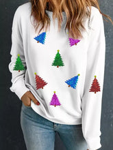 White long-sleeved festive sweatshirt with colorful glittery christmas tree patches, machine wash recommended