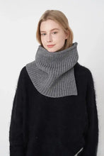 Woman in gray ribbed pullover knit scarf and black sweater