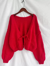 Vibrant red chunky knit tie-front cardigan with knotted detail and balloon sleeves