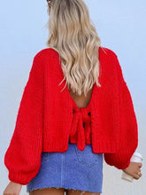 Back view of vibrant red chunky knit tie-front cardigan with stretchy back tie
